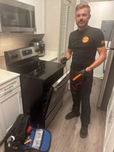 Fix It All Masters technician working on an appliance